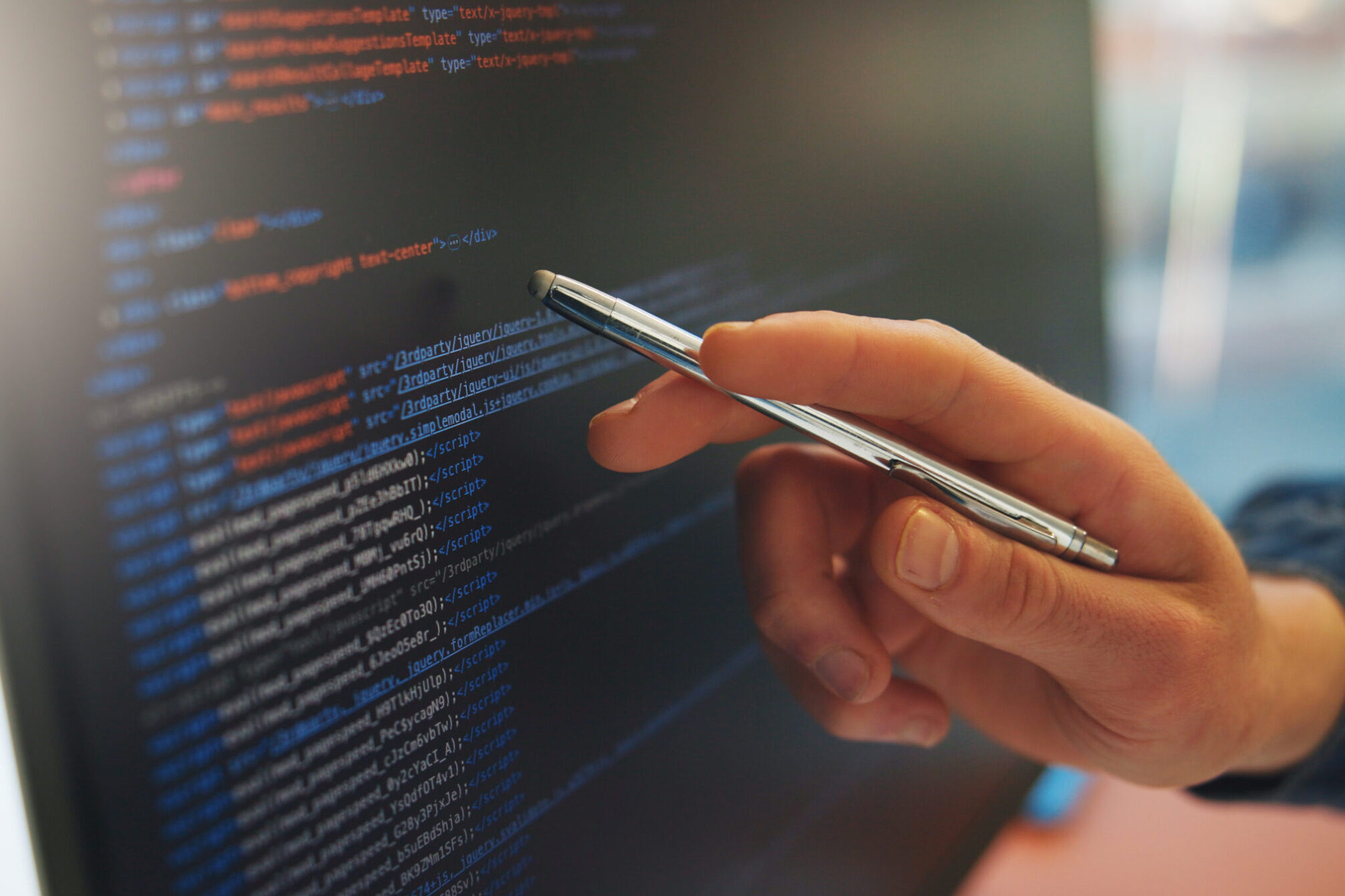 Woman working on electrical panel with tablet in a data center environment.