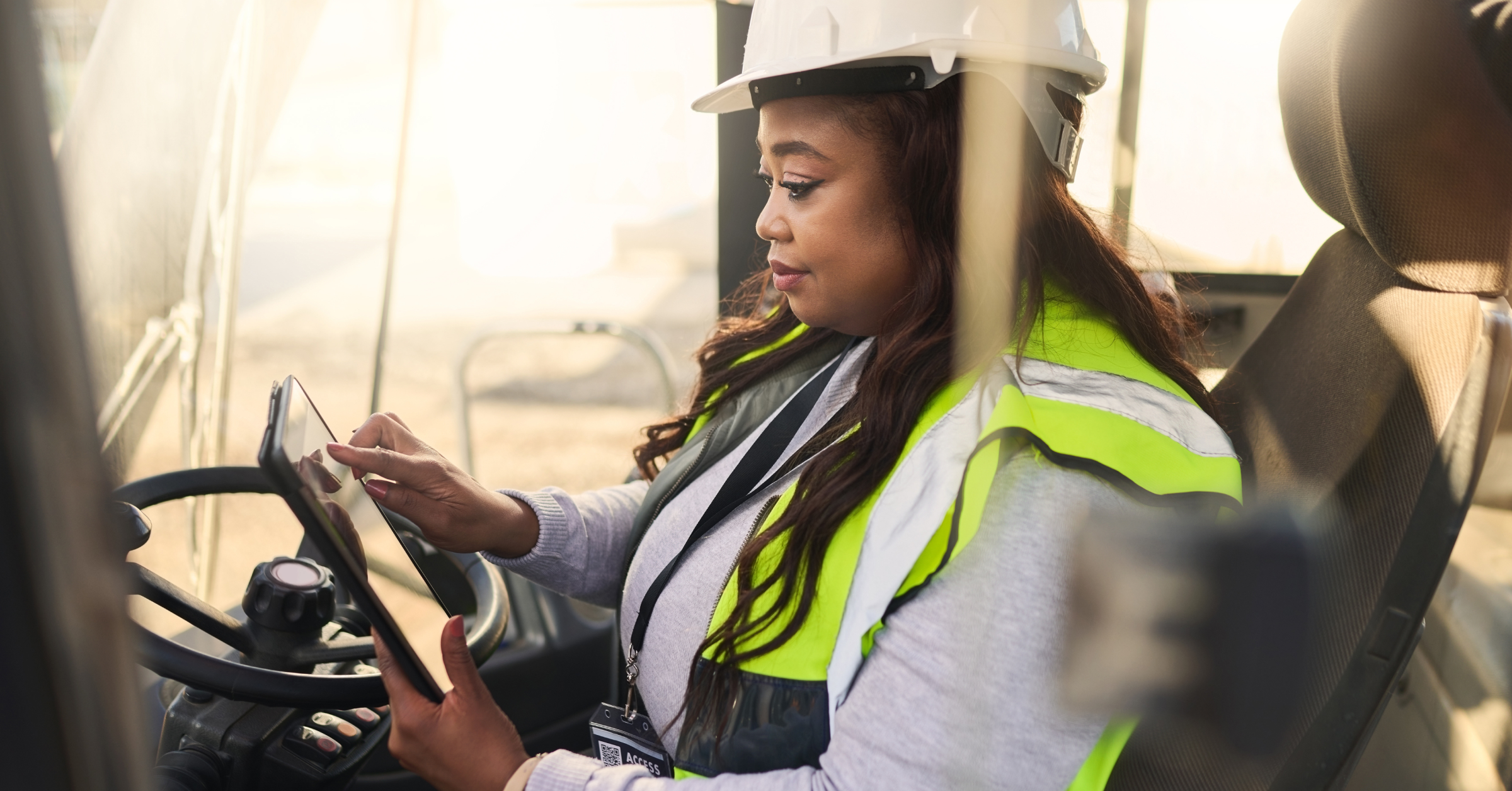 Woman communicating on a tablet on-site in mission-critical environment