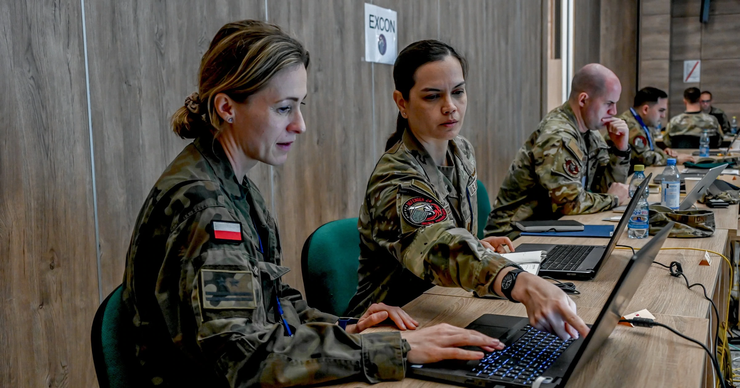 Maryland Air National Guard Capt. Kimberly Castellano, 275th Operations Support Squadron, partners with Poland Cyber Command leadership to oversee operations during a multinational cyber exercise as part of DEFENDER 24, May 13, 2024, in Warsaw, Poland.